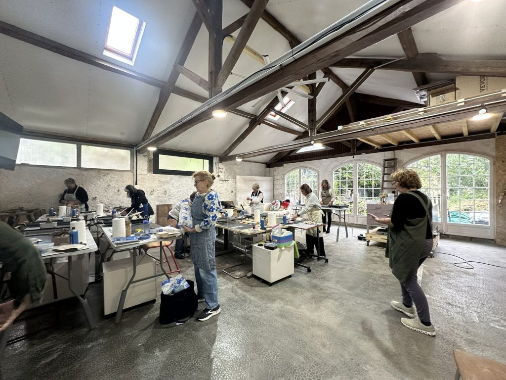 Artists at work in the large forge studio during a workshop